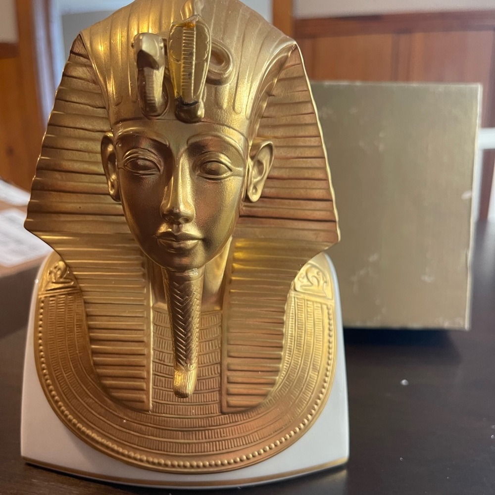 The Gold Mask of Tutankhamun. The snake has been chipped off his head piece.